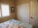 Bedroom with white closet doors and a cozy bed featuring a light blue throw blanket at 9705 Templemore Ave # 102, Las Vegas, NV 89129