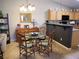 Cozy dining area with a glass table, wooden chairs, and a modern chandelier at 9705 Templemore Ave # 102, Las Vegas, NV 89129