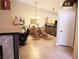 Open dining area with a dining table set and breakfast bar adjacent to the kitchen at 9705 Templemore Ave # 102, Las Vegas, NV 89129
