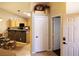 Bright, eat-in kitchen with bar seating, light wood cabinets, and black appliances at 9705 Templemore Ave # 102, Las Vegas, NV 89129