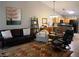 Spacious living room with leather seating, decorative rug, and open to the kitchen at 9705 Templemore Ave # 102, Las Vegas, NV 89129