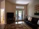 Cozy living room featuring a leather sofa, patterned rug, and bright natural light at 9705 Templemore Ave # 102, Las Vegas, NV 89129