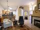 Open-concept living area with fireplace, kitchen, and view of the front entrance at 9705 Templemore Ave # 102, Las Vegas, NV 89129