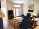 Inviting living room with a comfortable leather sofa and a decorative area rug at 9705 Templemore Ave # 102, Las Vegas, NV 89129