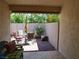 Cozy covered patio with outdoor seating, potted plants, and a view of the backyard at 9705 Templemore Ave # 102, Las Vegas, NV 89129