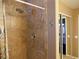 Modern tiled shower featuring a rainfall shower head, sleek fixtures, and a convenient grab bar at 9705 Templemore Ave # 102, Las Vegas, NV 89129