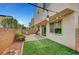 Backyard featuring artificial turf, brick paver patio, string lights, and a privacy wall at , Las Vegas, NV 89139