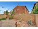 Inviting backyard featuring a brick patio, desert landscaping, string lights, and a cozy wooden chair at , Las Vegas, NV 89139