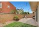 Backyard with brick patio, artificial grass, desert plants, and charming string lights overhead at , Las Vegas, NV 89139