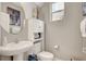 Charming powder room features pedestal sink, decorative mirror, and updated lighting at , Las Vegas, NV 89139