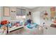 This colorful bedroom includes a crib, toys, and shelves full of books at , Las Vegas, NV 89139