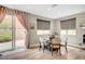 Dining area with a round table, neutral-toned chairs, and a sliding door to the backyard at , Las Vegas, NV 89139