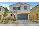 Charming two-story home featuring a neutral stucco exterior, arched entryway, and attached two-car garage at , Las Vegas, NV 89139