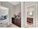 A hallway connects a bonus room and a bathroom with a cabinet in the foreground at , Las Vegas, NV 89139