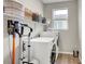 Well-organized laundry room with washer, dryer, shelving, and window at , Las Vegas, NV 89139