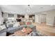 Spacious living room with hardwood floors, a gray sectional sofa, and an open layout connecting to the kitchen at , Las Vegas, NV 89139