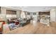 Open-concept living space featuring a gray sectional sofa, wood floors, and access to the kitchen at , Las Vegas, NV 89139