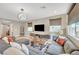 Living area with modern decor, hardwood floors, a large sofa, and a wall-mounted TV at , Las Vegas, NV 89139