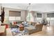 Bright living area with a large sectional sofa, wood floors, and neutral-toned walls at , Las Vegas, NV 89139