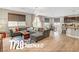 Open-concept living room with a large sectional sofa, wood floors, and a view of the kitchen at , Las Vegas, NV 89139