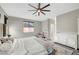 Bright main bedroom with plush decor, large windows, ceiling fan and ensuite bathroom at , Las Vegas, NV 89139