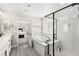 Bathroom with double vanity, soaking tub, glass enclosed shower, and tile floors at 10101 Heron Lake Ave, Las Vegas, NV 89178