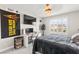 This bedroom features carpet, neutral walls, a ceiling fan, a bed, a window with shutters and desk at 10101 Heron Lake Ave, Las Vegas, NV 89178