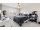 This bedroom features carpet, neutral walls, a ceiling fan, a bed, a window with shutters and desk at 10101 Heron Lake Ave, Las Vegas, NV 89178