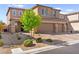 Charming two-story home features a two-car garage and a well-manicured front yard at 10101 Heron Lake Ave, Las Vegas, NV 89178