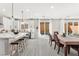 Bright kitchen with white cabinetry, a center island, and a dining area with pool views at 10101 Heron Lake Ave, Las Vegas, NV 89178