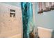 Bathroom with shower and bathtub combo featuring marble tile and modern fixtures at 104 Glendive St, Henderson, NV 89012