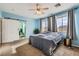 Bright bedroom with a ceiling fan, natural light, and access to ensuite bathroom at 104 Glendive St, Henderson, NV 89012