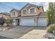 Two-story home with a three-car garage and a well-manicured front yard featuring desert landscaping at 104 Glendive St, Henderson, NV 89012