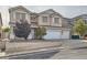 Two-story home with a three-car garage and a well-manicured front yard featuring desert landscaping at 104 Glendive St, Henderson, NV 89012