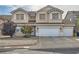 Two-story home with a three-car garage and a well-manicured front yard featuring desert landscaping at 104 Glendive St, Henderson, NV 89012