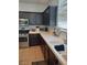 Kitchen with dark cabinets, white counters, and stainless steel appliances at 104 Glendive St, Henderson, NV 89012