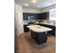 Kitchen featuring dark cabinets, center island, stainless steel appliances and tile floors at 104 Glendive St, Henderson, NV 89012