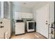 Laundry room with a new washer, dryer and a white storage cabinet at 104 Glendive St, Henderson, NV 89012