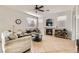 Cozy living room with fireplace, neutral paint, tile flooring, and bright windows at 104 Glendive St, Henderson, NV 89012