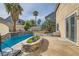 Backyard pool featuring a water feature, planter, lounge area, and mature trees at 104 Glendive St, Henderson, NV 89012