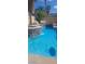 Backyard oasis featuring a pool, tanning shelf, waterfall features, lush landscaping and a spa at 104 Glendive St, Henderson, NV 89012