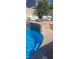 Backyard oasis featuring a pool, tanning shelf, waterfall features, a fire pit and outdoor seating at 104 Glendive St, Henderson, NV 89012