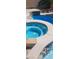 Backyard oasis featuring a pool, tanning shelf, waterfall features, and a built in spa at 104 Glendive St, Henderson, NV 89012