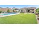 Large backyard with a pool, spa, and artificial grass, great for entertaining at 10601 Skye Arroyo Ave, Las Vegas, NV 89166