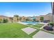 Landscaped backyard features a modern pool and pristine lawn at 10601 Skye Arroyo Ave, Las Vegas, NV 89166