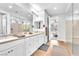 Elegant bathroom with dual sinks, large mirror, and walk-in shower at 10601 Skye Arroyo Ave, Las Vegas, NV 89166