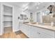 Bright bathroom featuring double sinks, stone countertops, and an adjacent walk-in closet, providing ample storage at 10601 Skye Arroyo Ave, Las Vegas, NV 89166