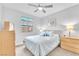 Comfortable bedroom featuring a ceiling fan, natural light, and plush bedding at 10601 Skye Arroyo Ave, Las Vegas, NV 89166