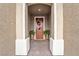 Inviting front entrance with a decorated door, stylish brickwork, and charming potted plants at 10601 Skye Arroyo Ave, Las Vegas, NV 89166