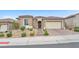 Charming single-story home featuring a tile roof, desert landscaping, and a two-car garage at 10601 Skye Arroyo Ave, Las Vegas, NV 89166